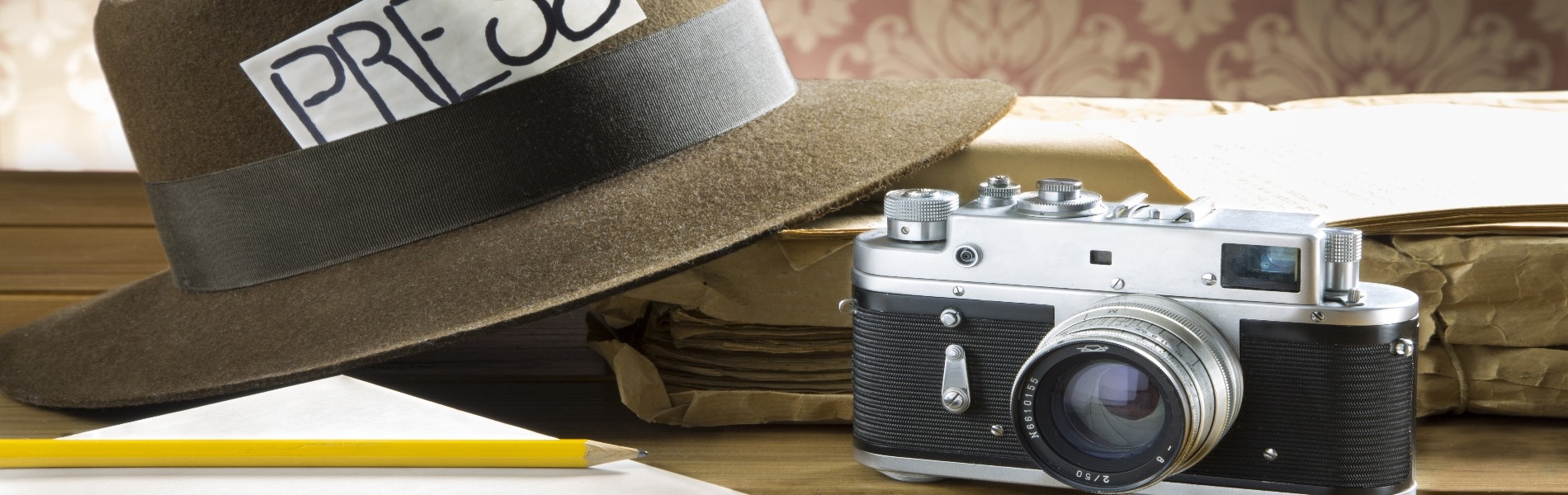 Pencil, camera and trilby with press card