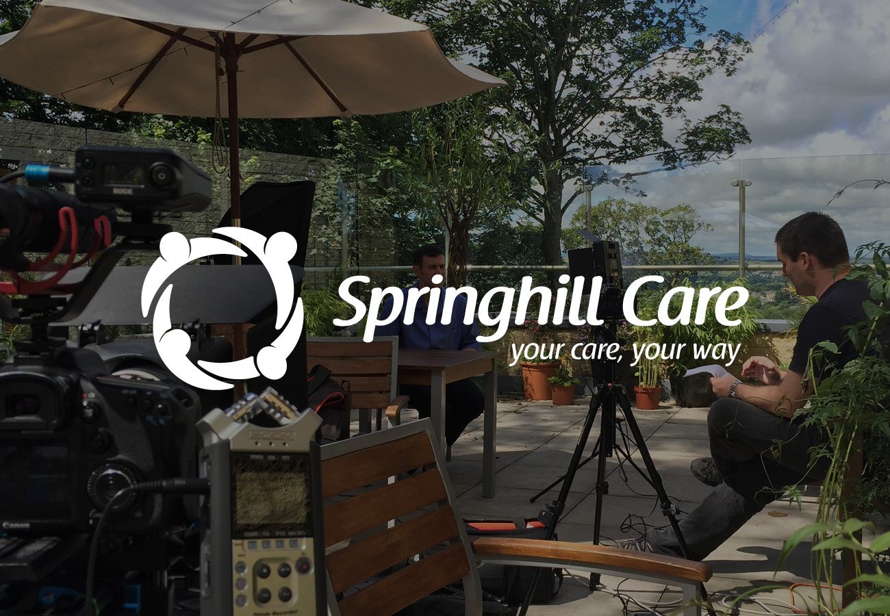 Springhill Care logo over image of filming an interview
